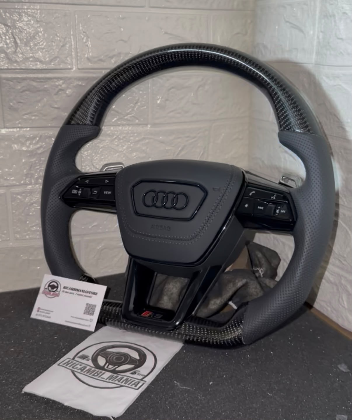 Volante per audi con pelle traforata e carbonio lucido, cn cuciture nere, tasti multifunzione e paddle